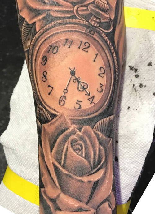 Clock and rose tattoo done by Rana ramos