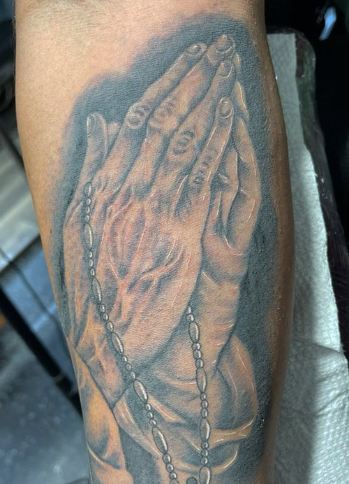 Praying hands tattoo done by Rene Pain ink